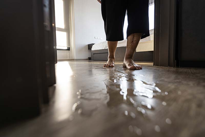 Senior woman is stepping on the wet floor how to prevent and care of the elderly safe